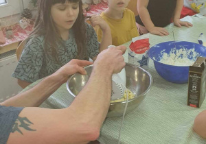 Dzieci przyglądają się, jak pan Kucharz miksuje masło.